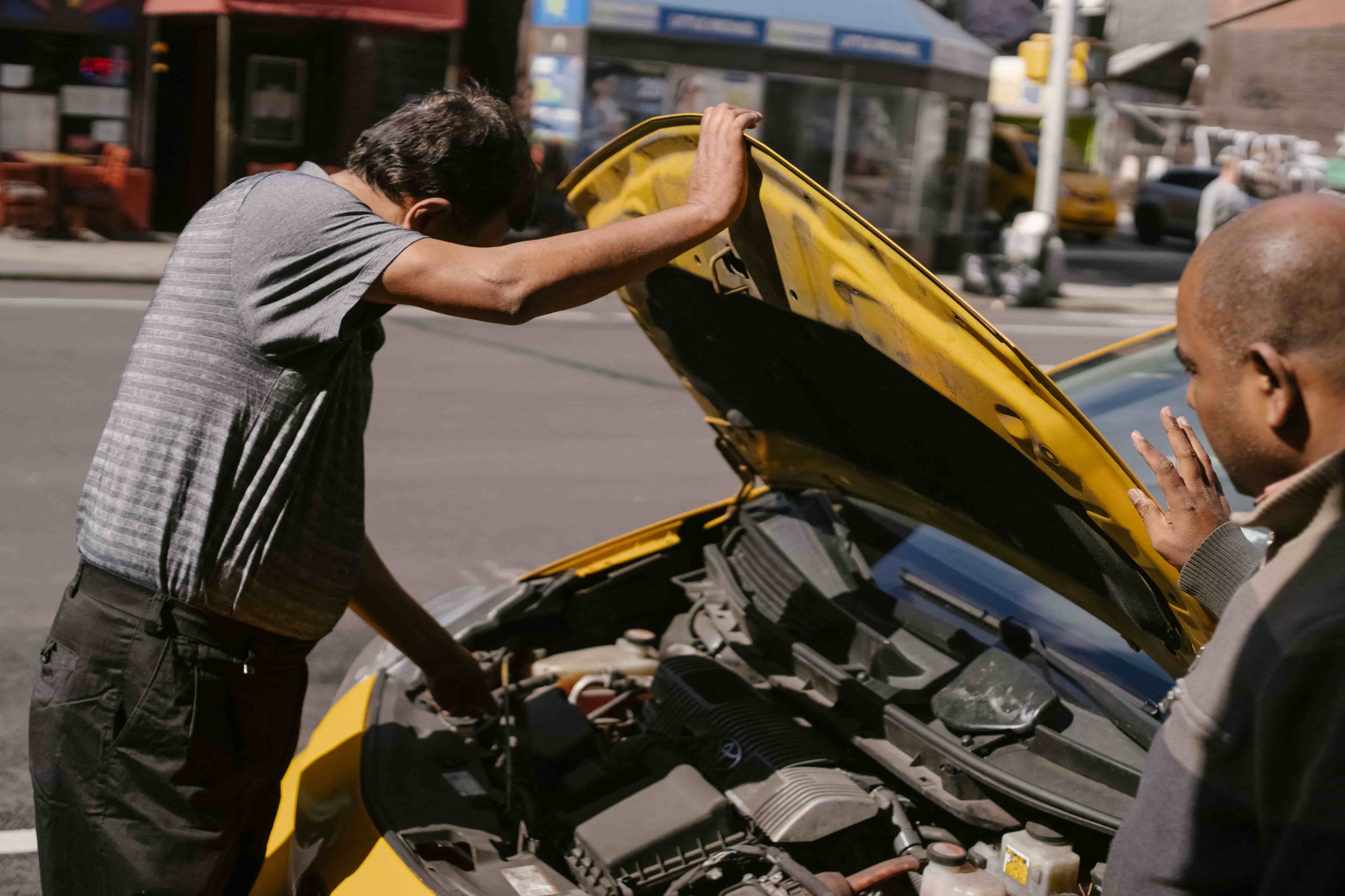 On-site car repair with the hood up in a Clarksville parking lot